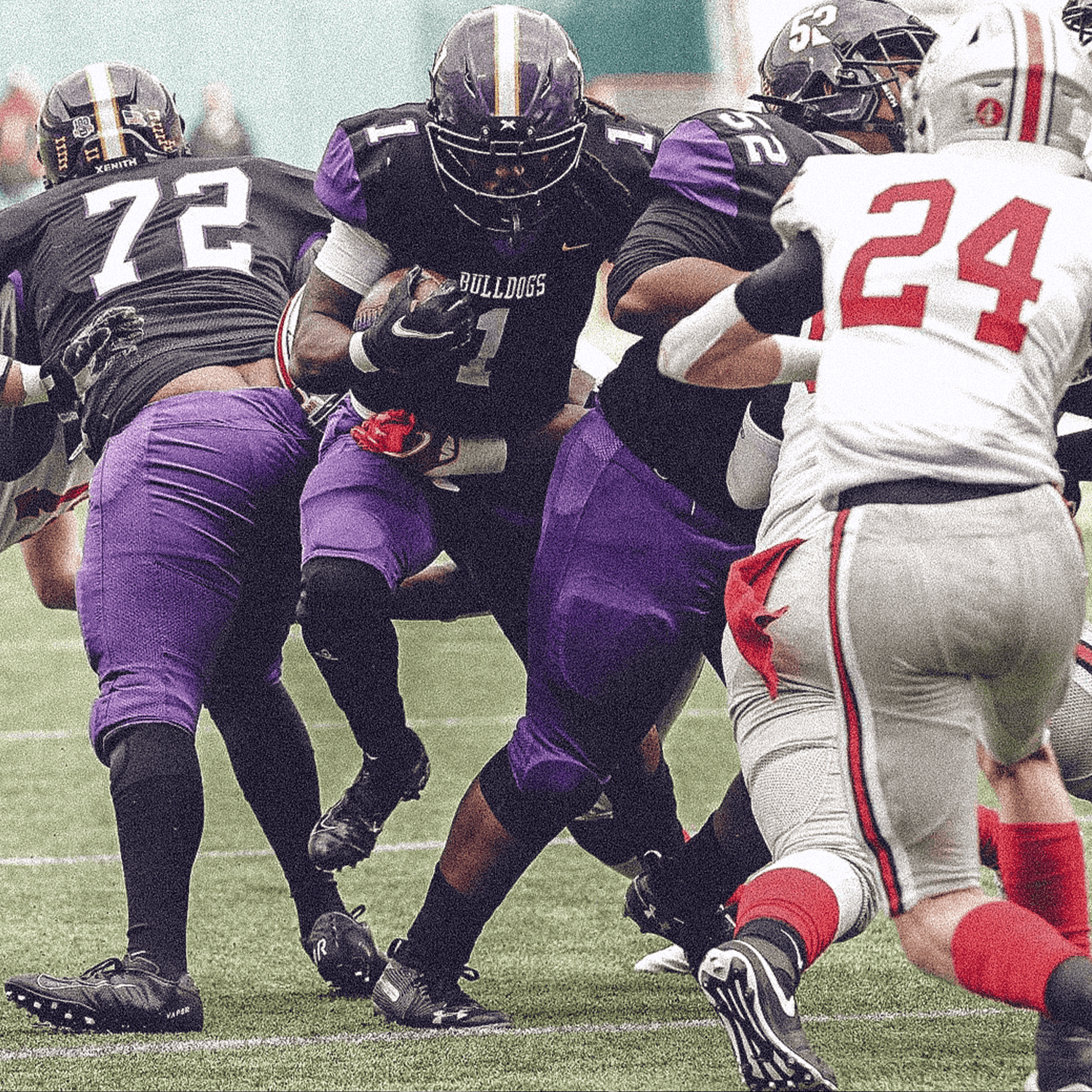 Football player carrying the ball, running between blockers.