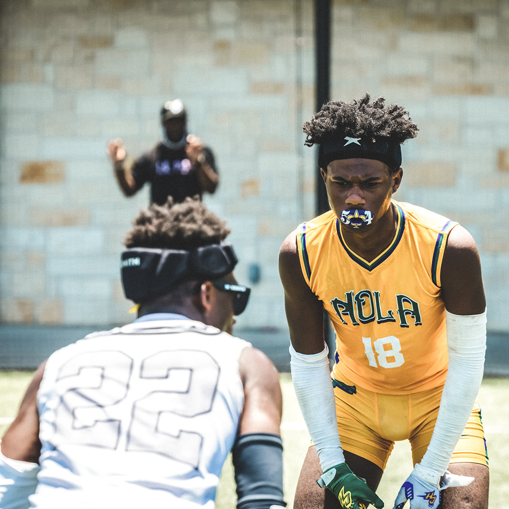 Two football players wearing Xenith LOOP face each other before a play.