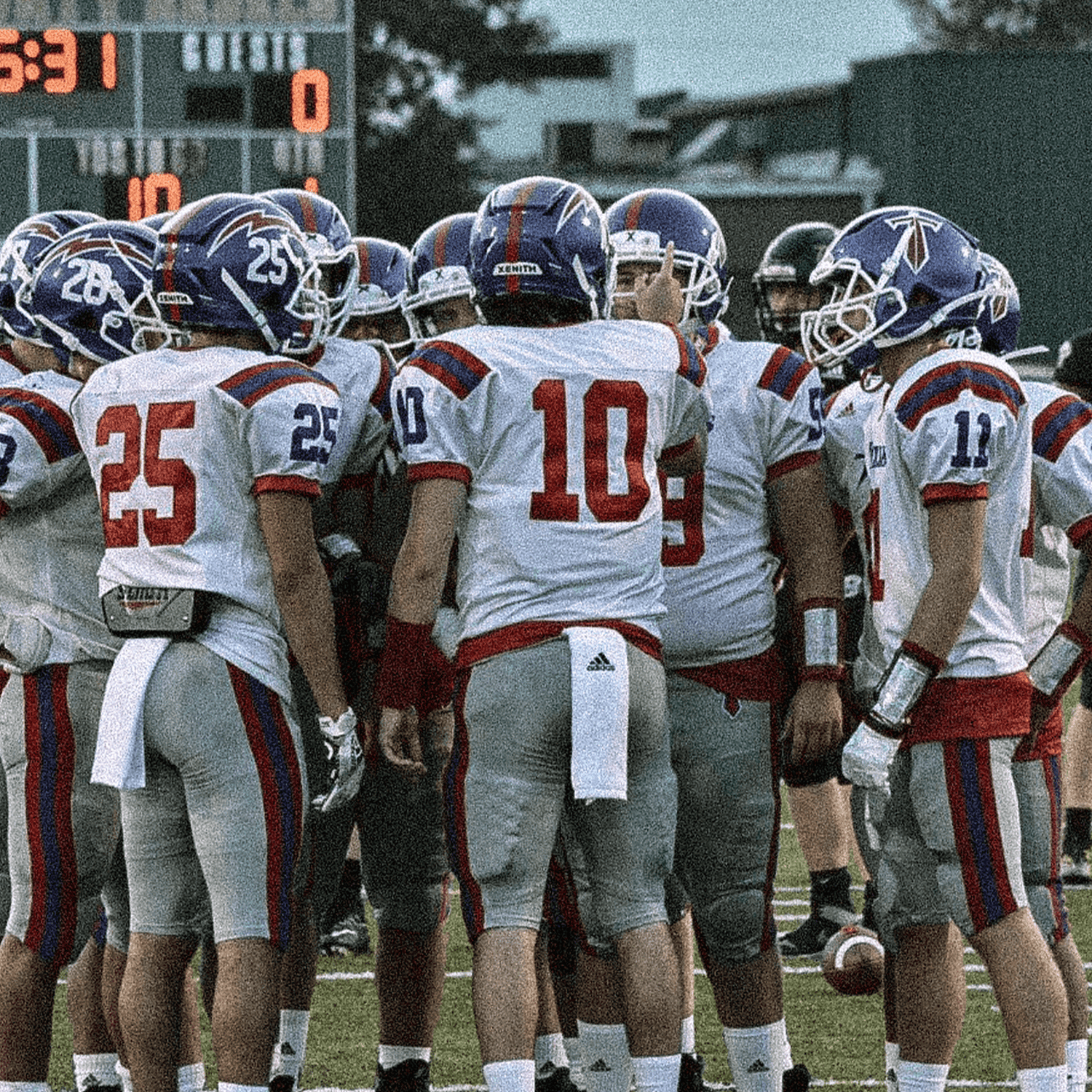 Players huddle to discuss the next play during a game.