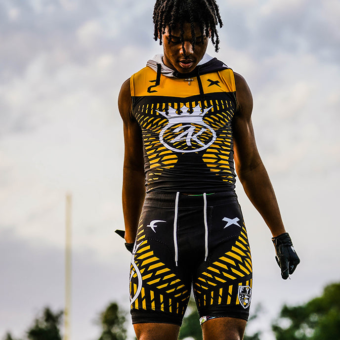 Athlete looking down at his uniform.