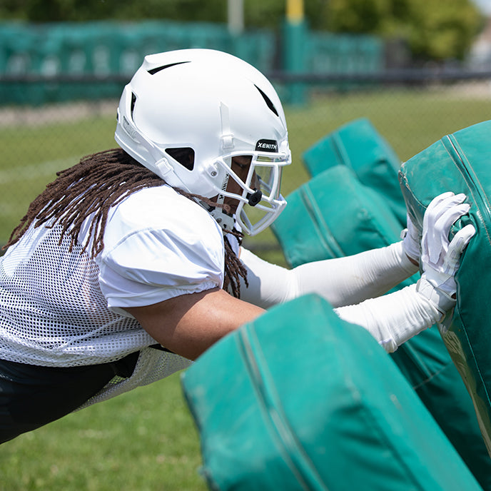 Football player practicing while wearing Xenith football gear.