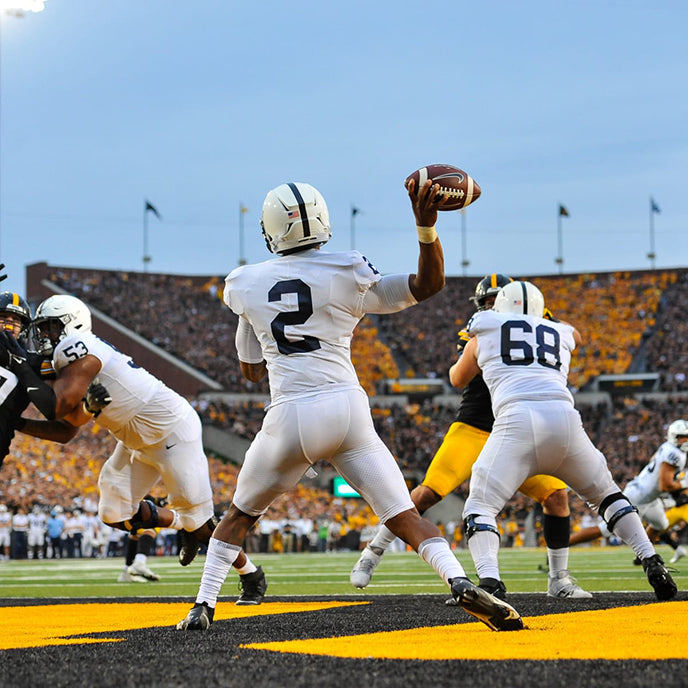 Football player with back turned throwing the ball.