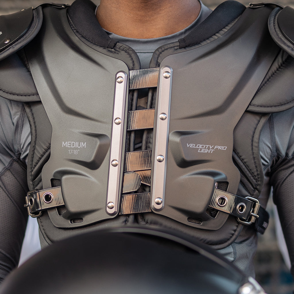 Close up shot of three athletes wearing Xenith Injection Molded Shoulder Pads.