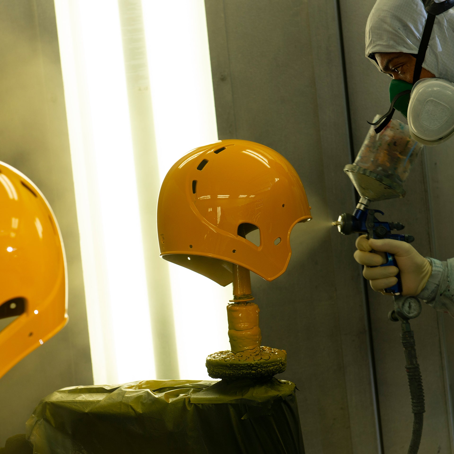 A Xenith football helmet being painted during the reconditioning process.