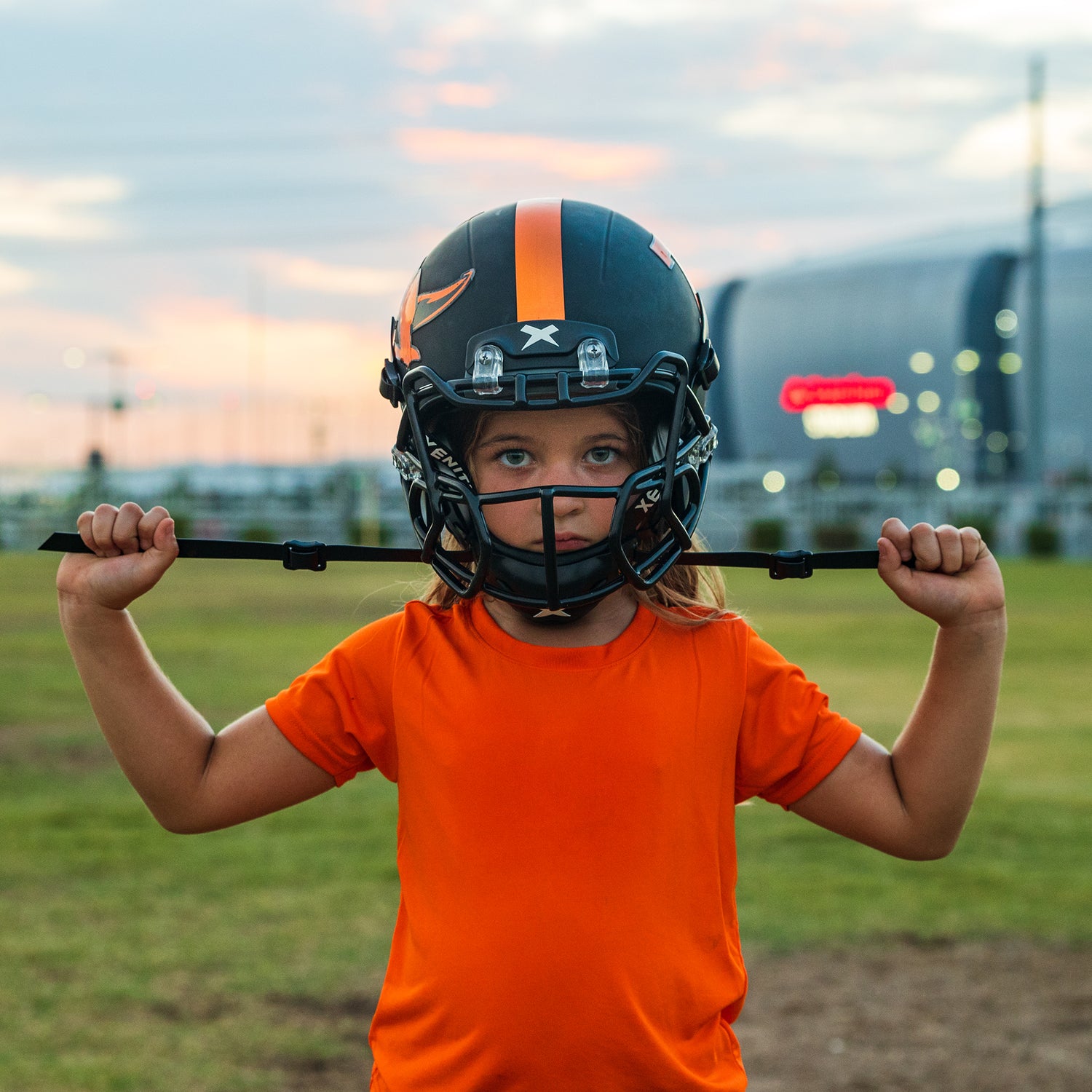 A football player pulls on the Integrated Xenith Chinstrap to adjust the fit of the Internal Shock Matrix.