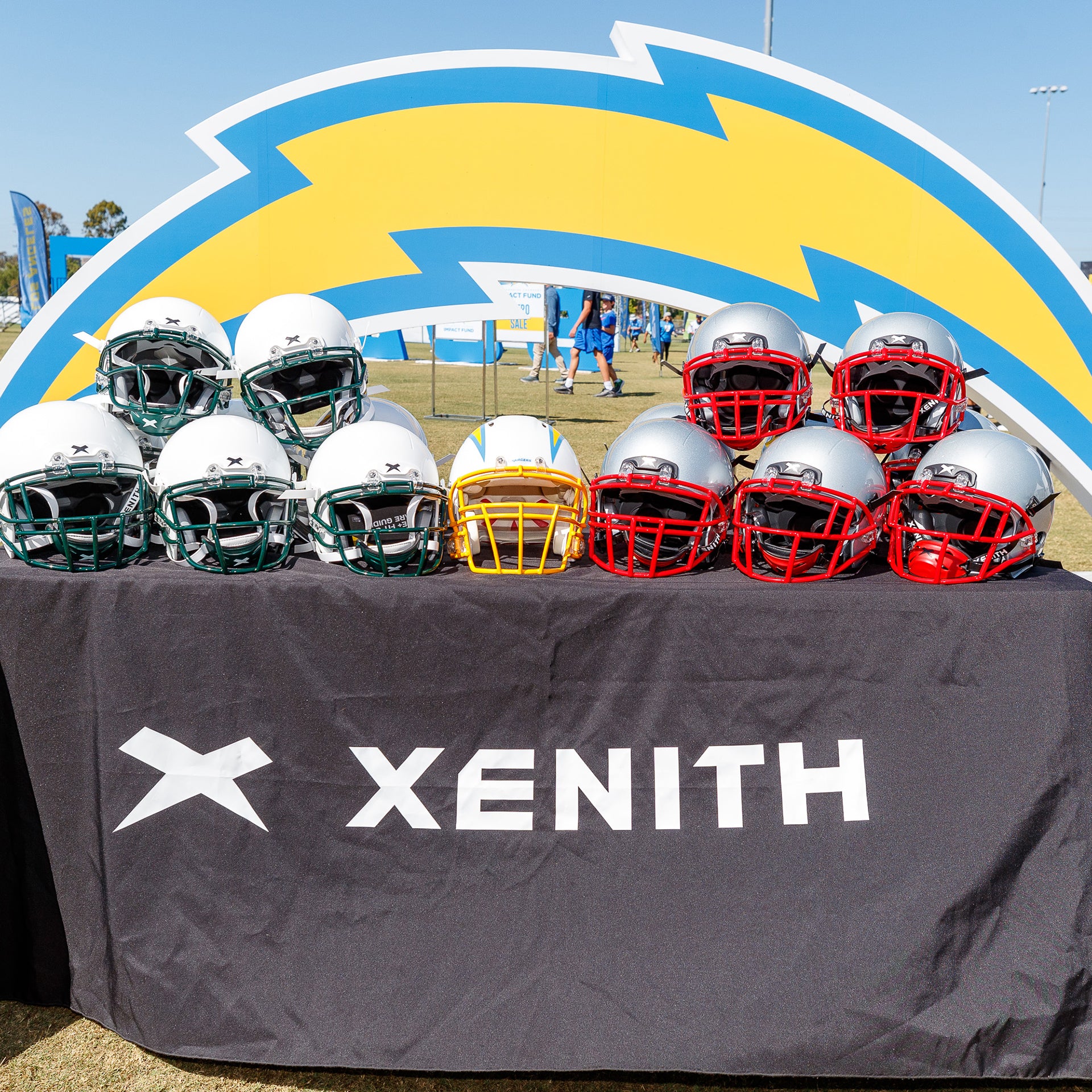 Xenith football helmets displayed on a table.