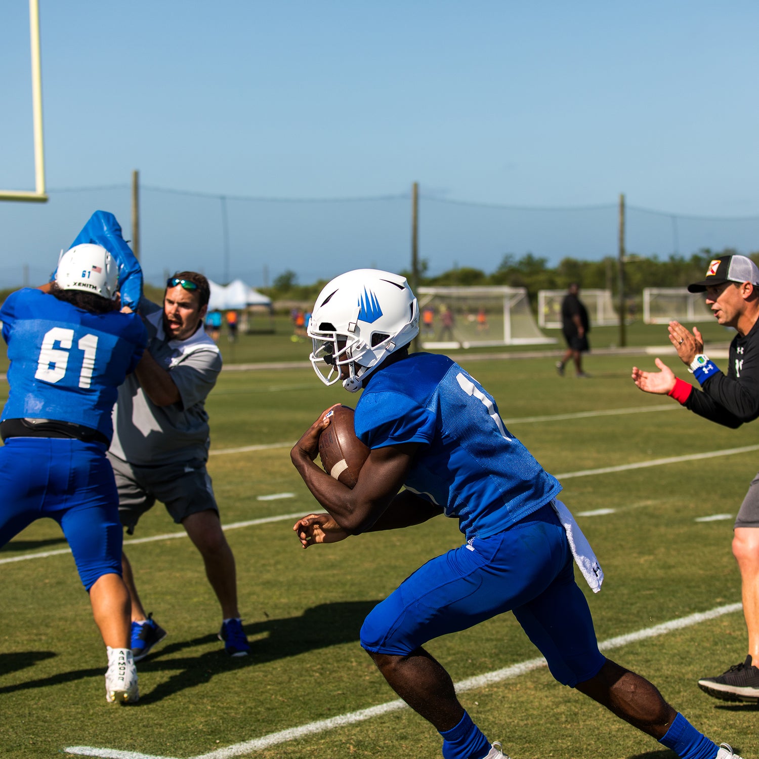 A running back going through drills during practice.