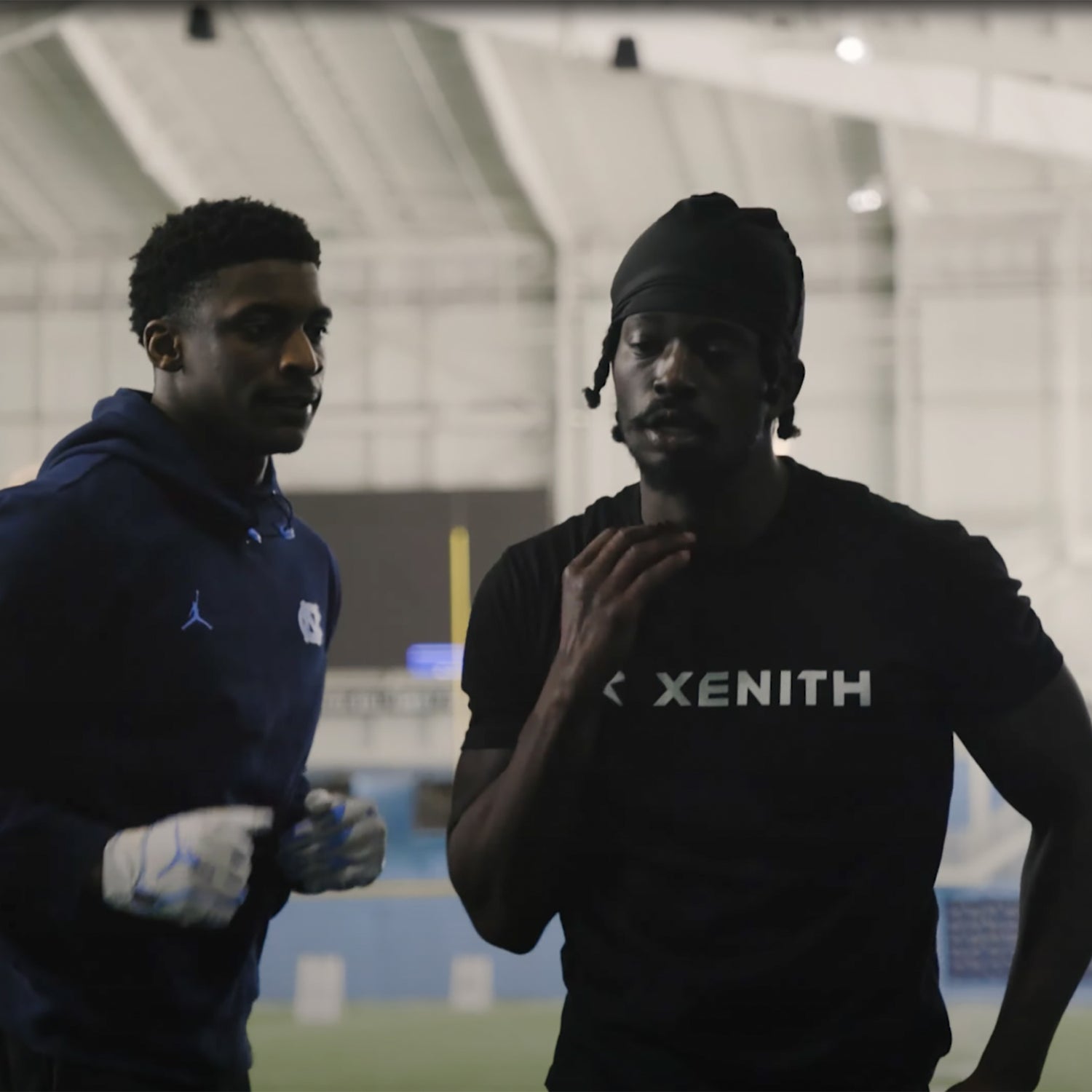 Roc Carmichael running drills with a football player.