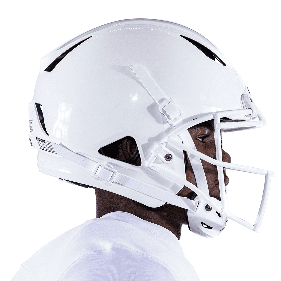 Side view of white XRS-21X Facemask attached to white helmet worn on athlete.