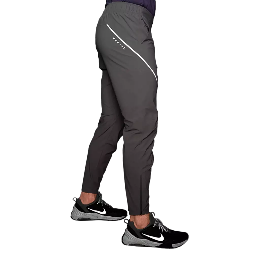 Male model wearing black pant with reflective stripes, from rear.