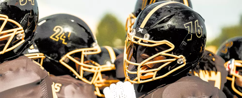 Athletes wearing Black Xenith Shadow helmets with a Yellow facemask.