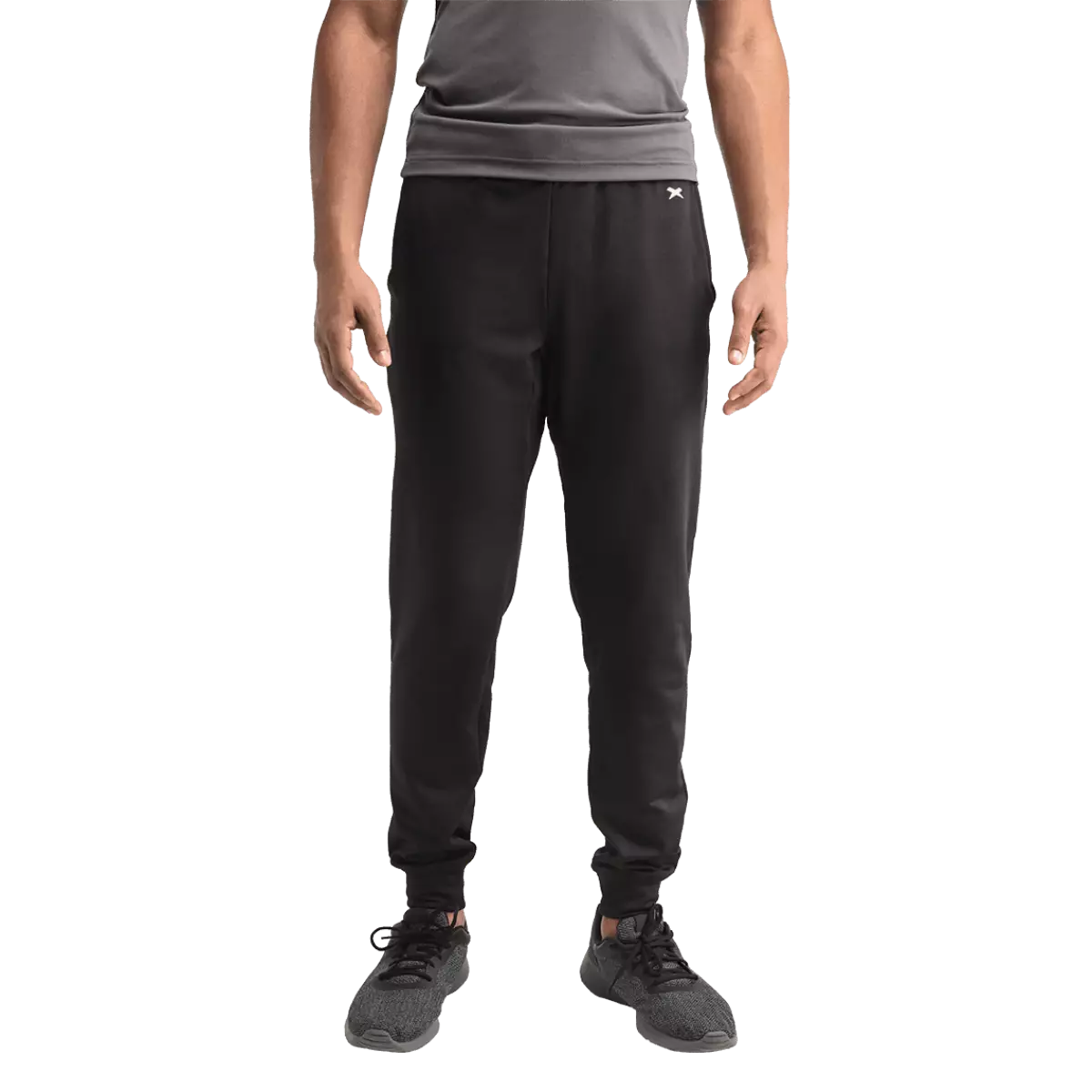 Male model wearing black jogger pants with white Xenith-X logo, from front.