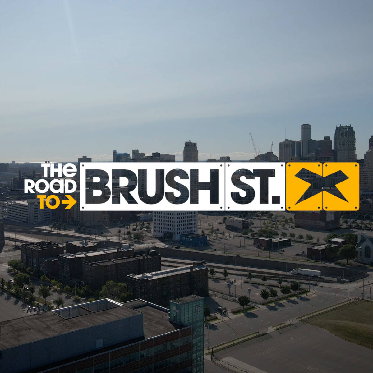 Drone shot of downtown Detroit with the words "The Road to Brush St." next to the Xenith logo.