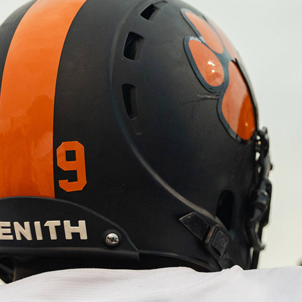 Close up of two athletes wearing Xenith X2E+ helmets facing away from the camera.