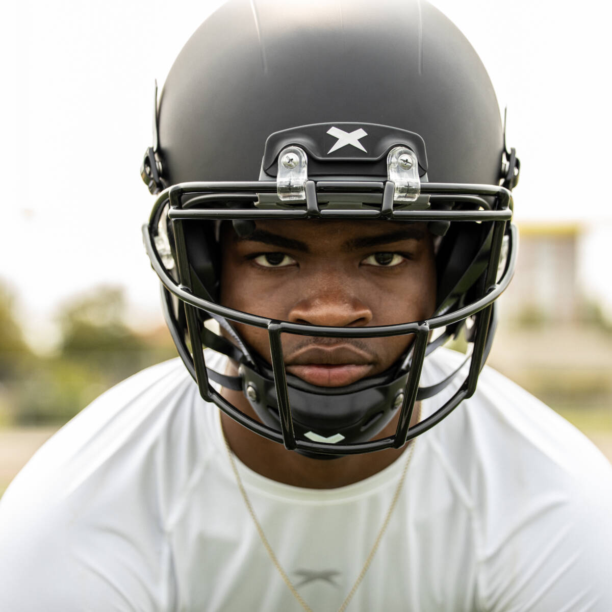 Close-up of a player wearing a Xenith football helmet looking into the camera.