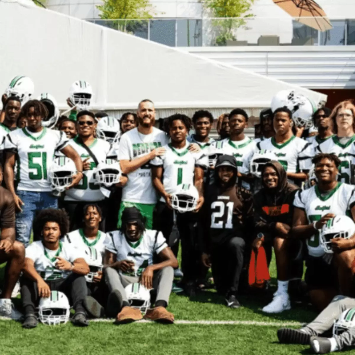 The Bedford High School football team posing together with their new Xenith helmets.