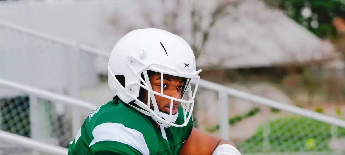 Close up of a football player wearing a white Xenith helmet.