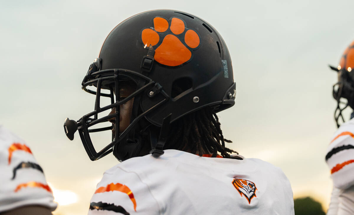 Close up shot of a football player looking over his shoulder and wearing an X2E+ helmet.