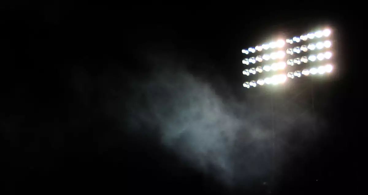 Dark sky with stadium lights shining on the right side.