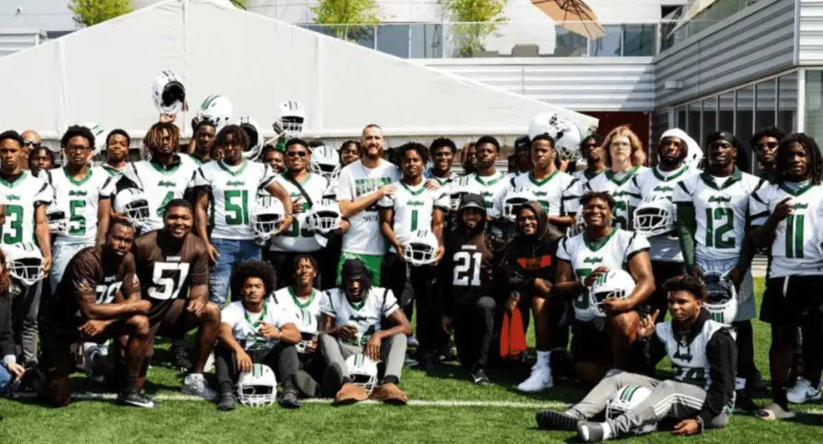 The Bedford High School football team posing together with their new Xenith helmets.