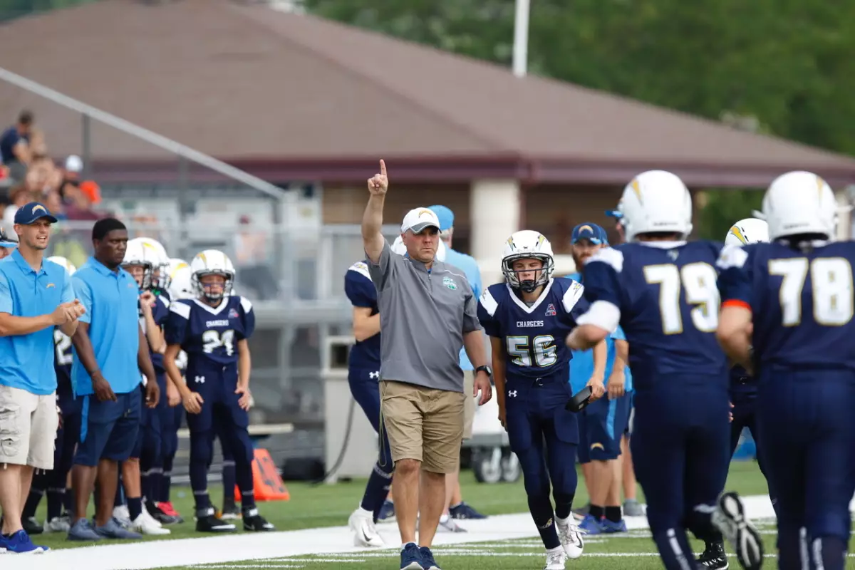 Nick Salm coaching on the sidelines during a football game.