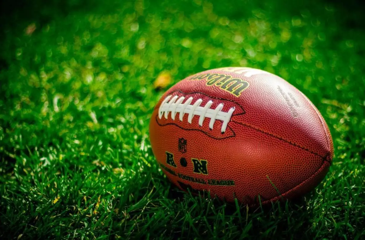 Close up of an American football on grass