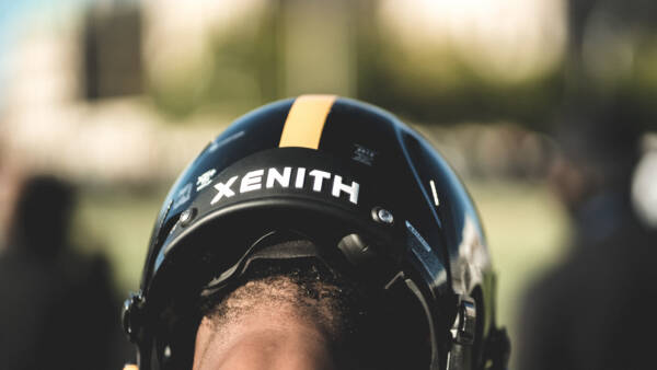 Close up of the backside of a player looking down while wearing a Xenith helmet.