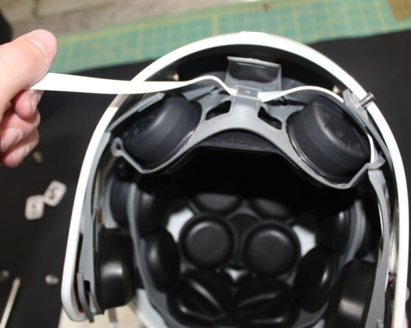 Close up view showing how to pull the chin strap through a Xenith X2E+ shock liner.