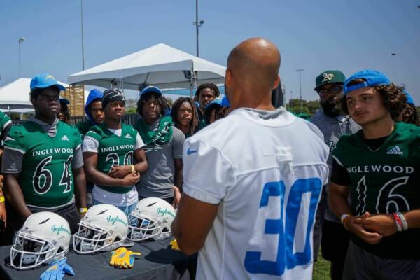 Austin Ekeler talking to Inglewood football players while checking out the new equipment.