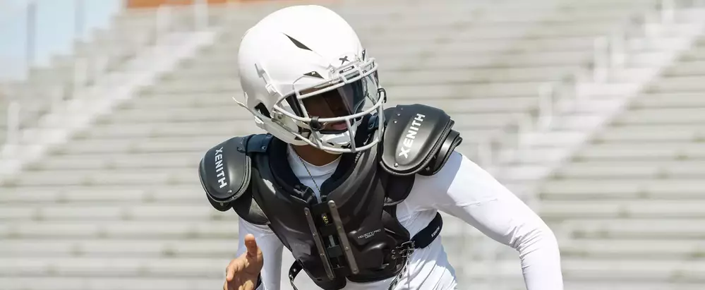 Close up of a player running drills, wearing Xenith football gear.