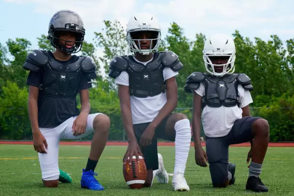 3 youth football players all wearing Xenith Flyte 2 SF shoulder pads