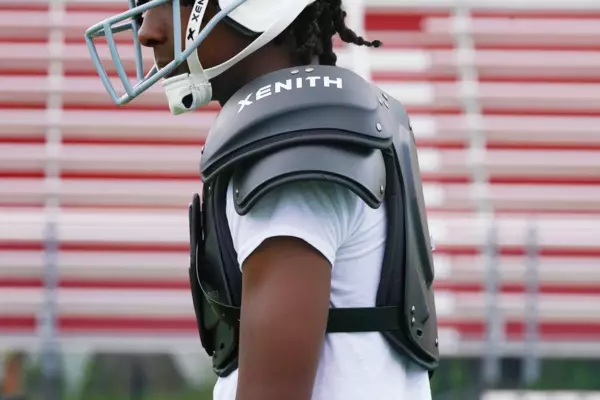 side angle picture of a youth football player wearing xenith flyte 2 td shoulder pads