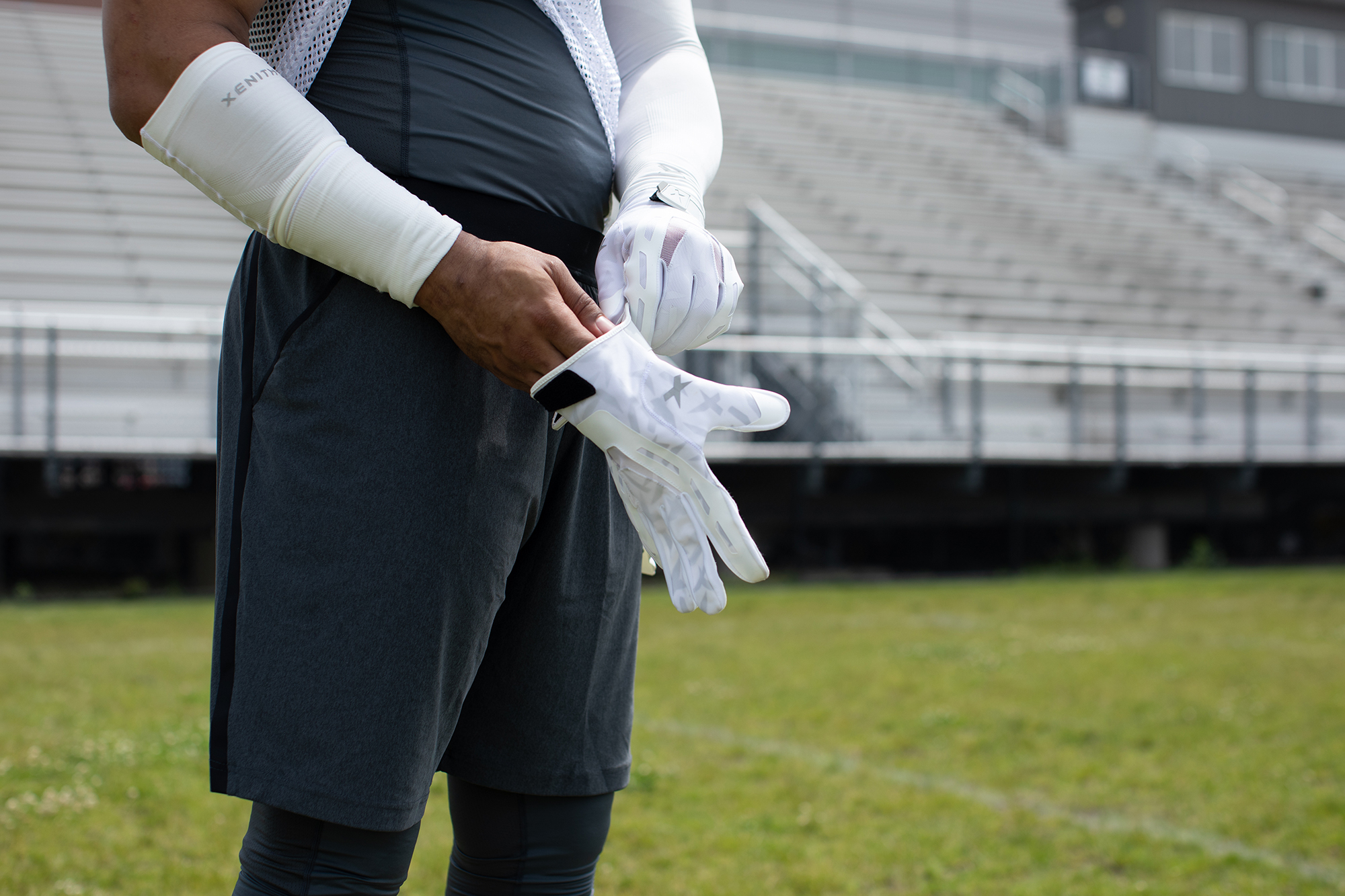 A player putting on Xenith Precision Receiver gloves.